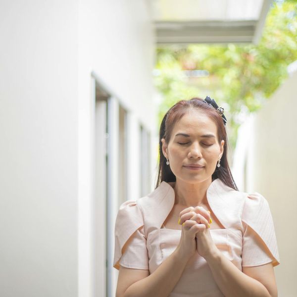 A person meditating peacefully with a calm expression.